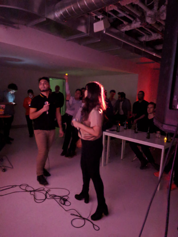 photo of two people singing karaoke